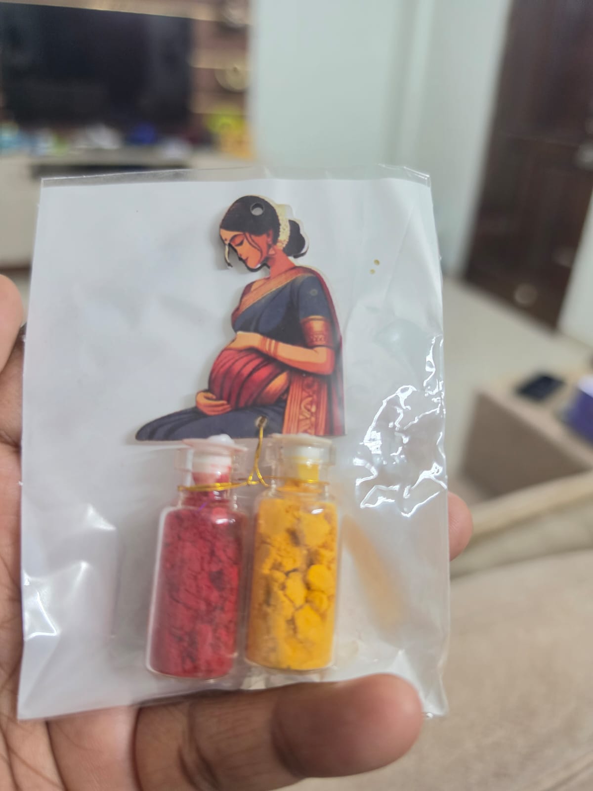 Seemantham themed kumkum and turmeric set with an illustrated cutout