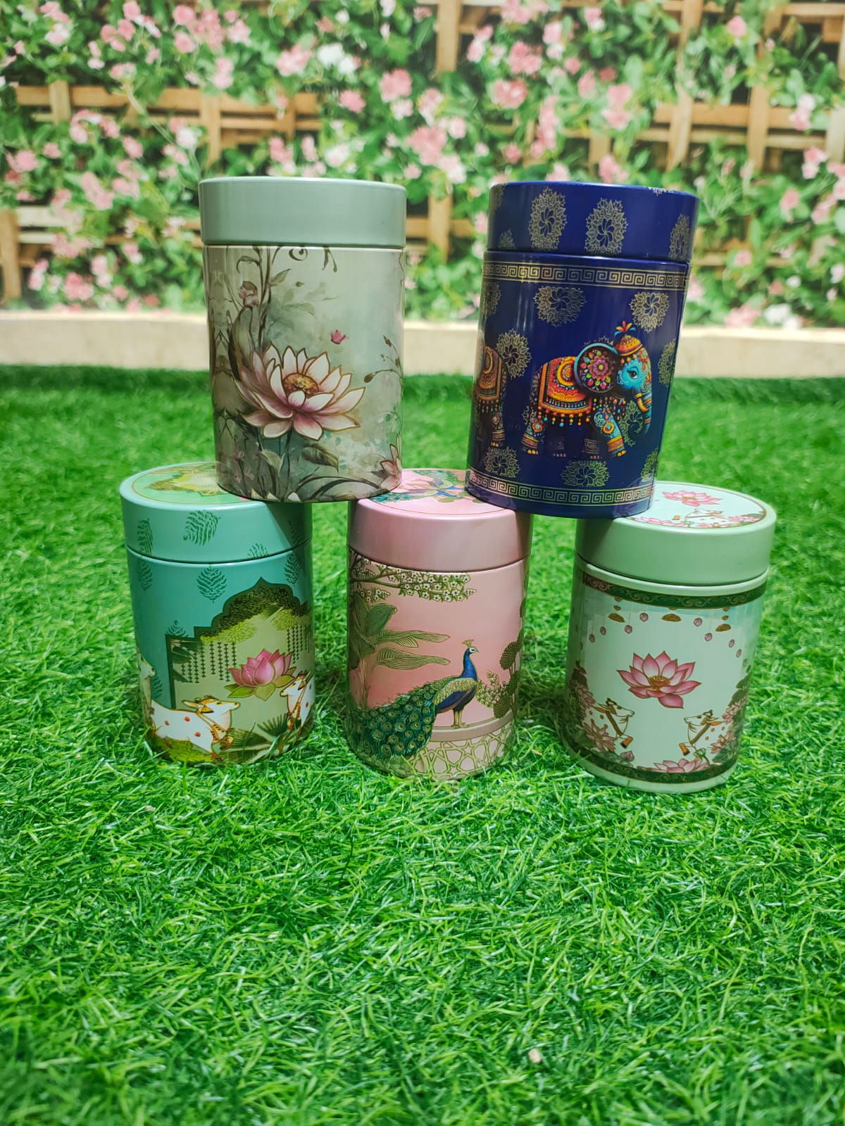 Assorted pastel printed tin canisters with lotus, elephant and peacock designs